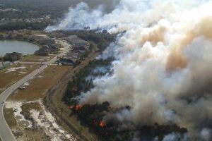 Aerial of a prescribed fire burning next to a neighborhood