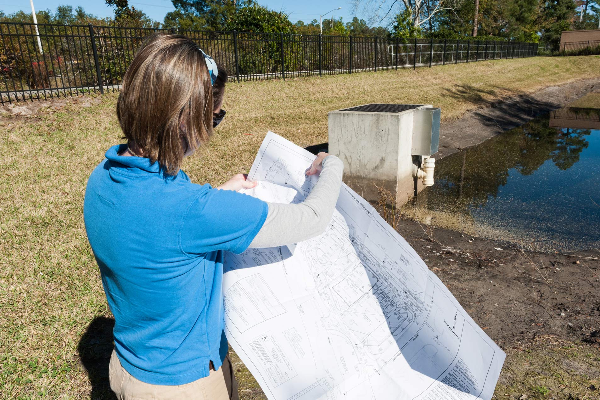 Permitting-staff District regulatory staff holding blueprints