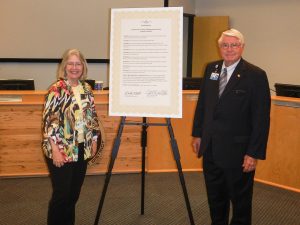  Dr. Ann Shortelle and Gen. Douglas Burnett standing next to a signed proclamation