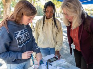 Dr. Ann Shortelle showing students water-quality technology