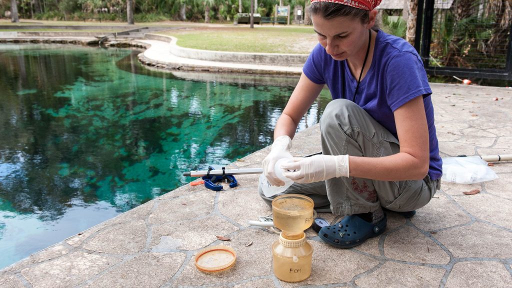 Tiffany Trent testing water next to a pool