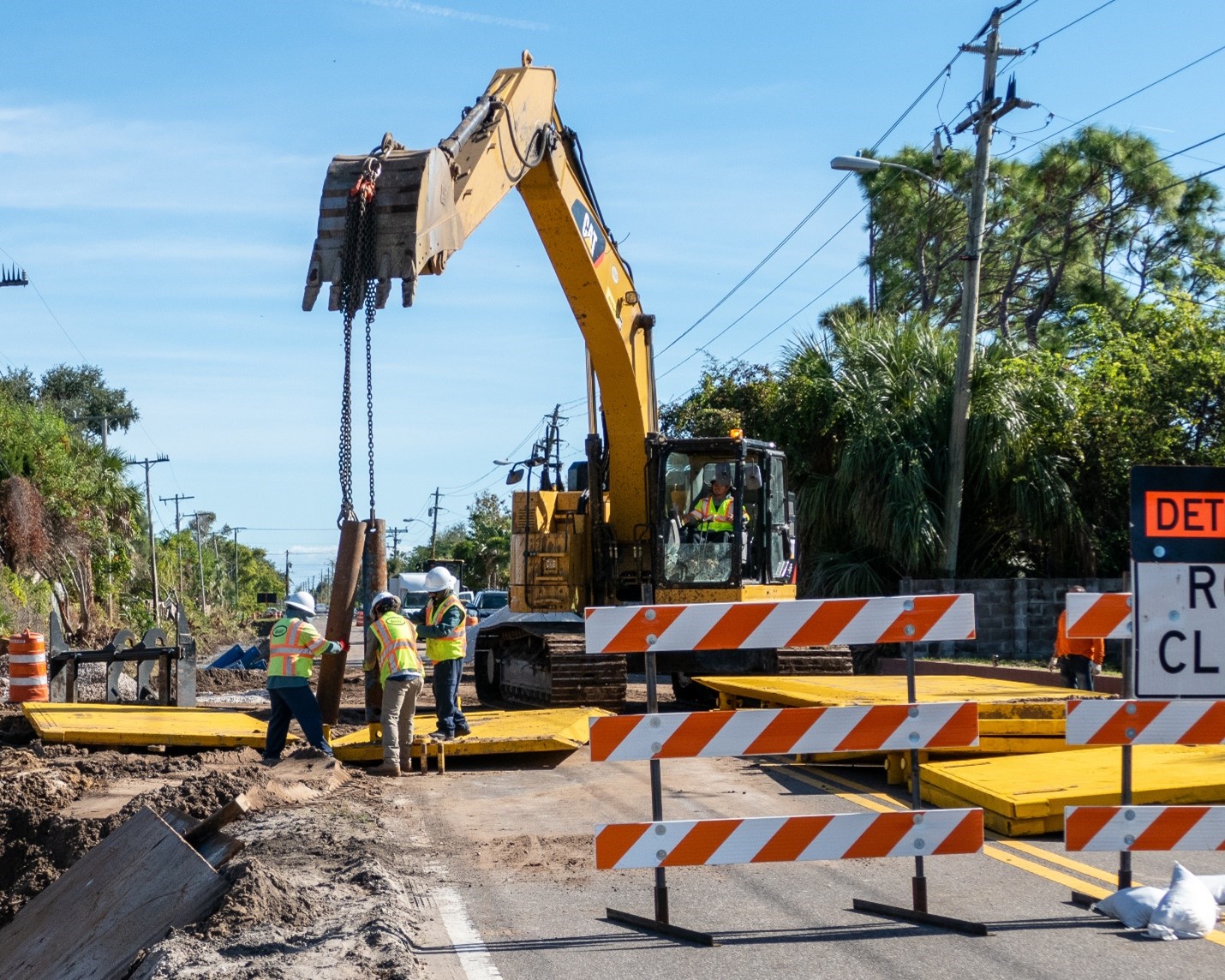 Workers install central sewer lines