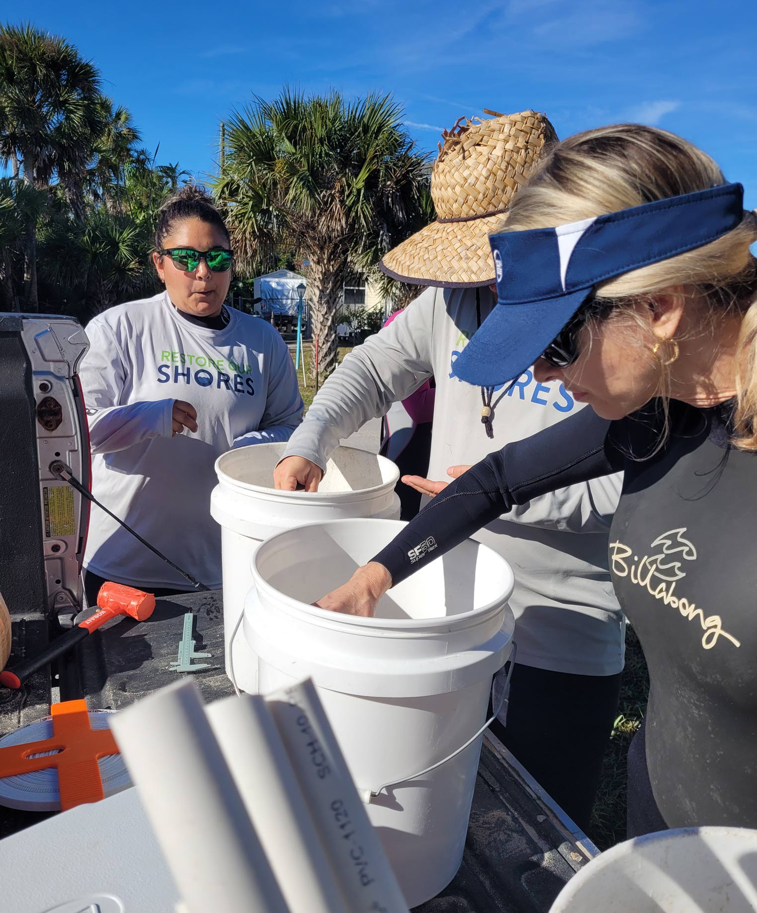District staff inspecting buckets of young clams