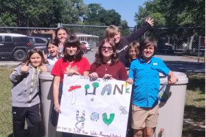 Students holding a sign